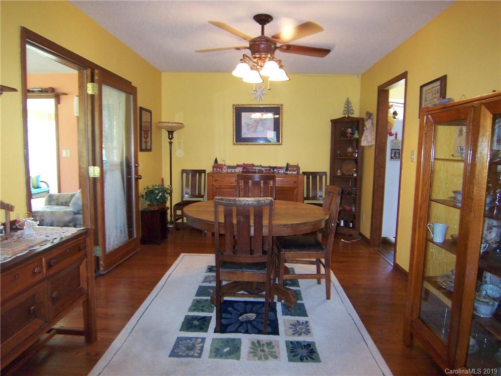 124 Laren Road Shelby, NC 28152 - Photo 11 of 30 a dining room with furniture a rug a rug and a chandelier