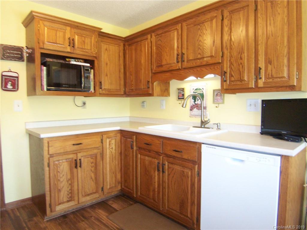 124 Laren Road Shelby, NC 28152 - Photo 13 of 30 a kitchen with a sink cabinets and wooden floor
