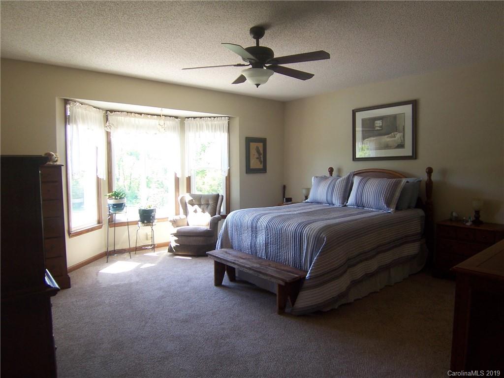 124 Laren Road Shelby, NC 28152 - Photo 16 of 30 a spacious bedroom with a bed and a couch