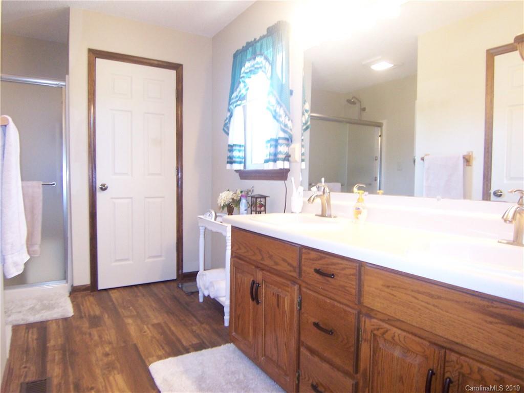 124 Laren Road Shelby, NC 28152 - Photo 18 of 30 a bathroom with a sink a mirror and a shower