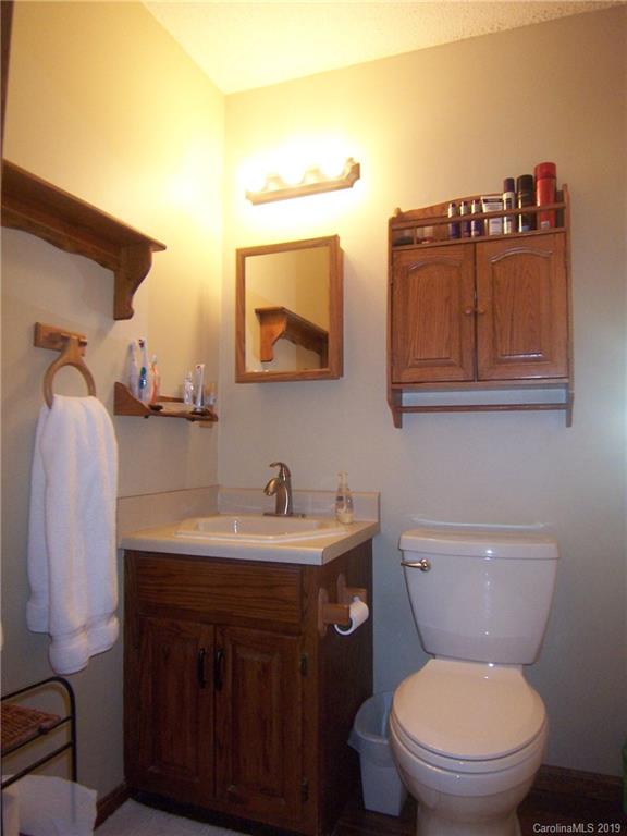 124 Laren Road Shelby, NC 28152 - Photo 21 of 30 a bathroom with a toilet a sink and mirror