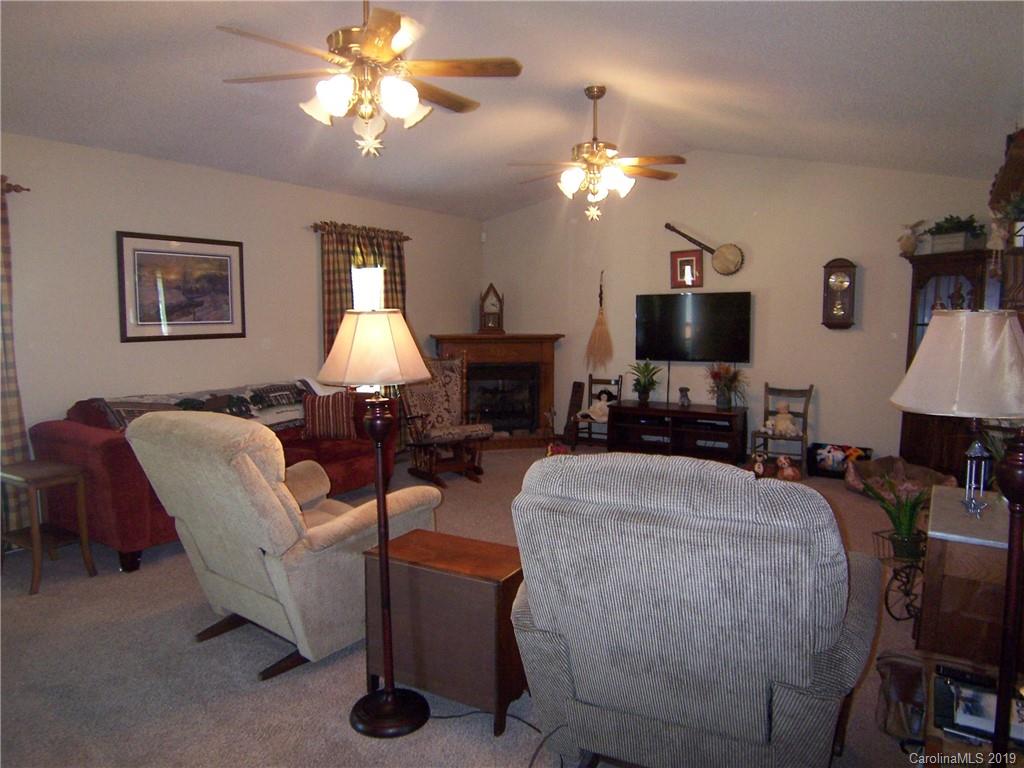 124 Laren Road Shelby, NC 28152 - Photo 8 of 30 a living room with furniture a lamp and a flat screen tv