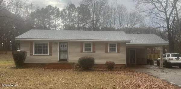 a front view of a house with parking space