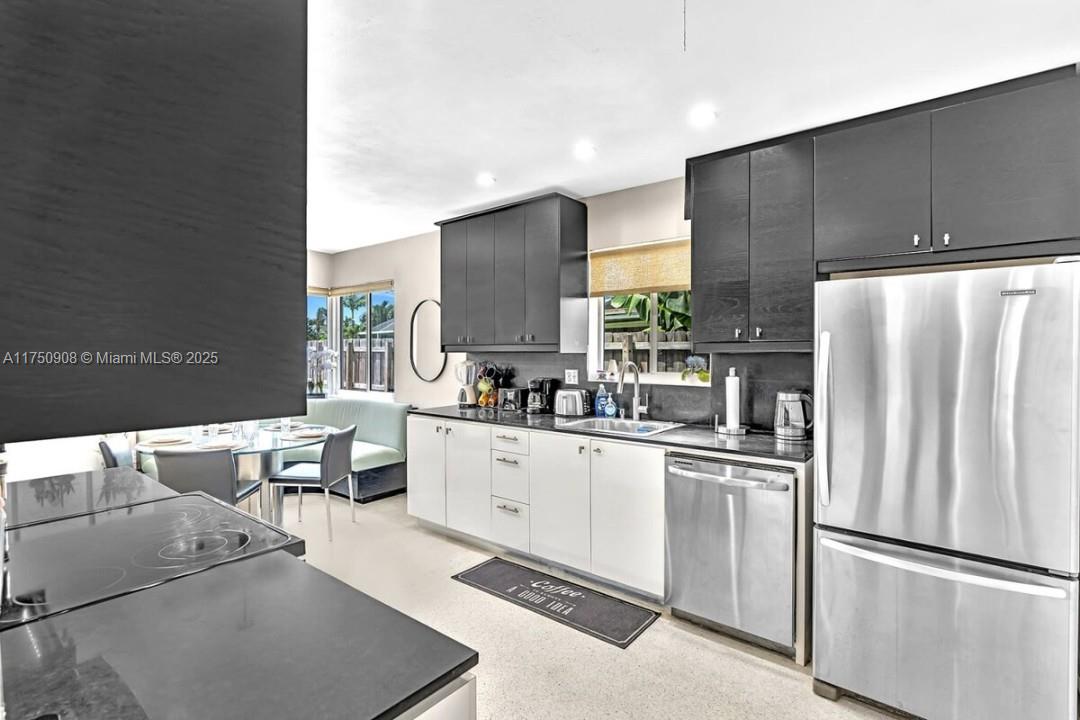 4316 Garfield Street Hollywood, FL 33021 - Photo 15 of 36 a kitchen with stainless steel appliances a refrigerator and a stove top oven