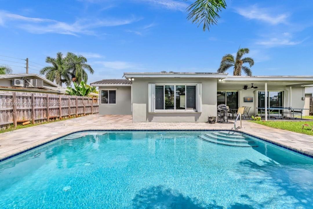 4316 Garfield Street Hollywood, FL 33021 - Photo 17 of 36 a view of a house with swimming pool and a yard