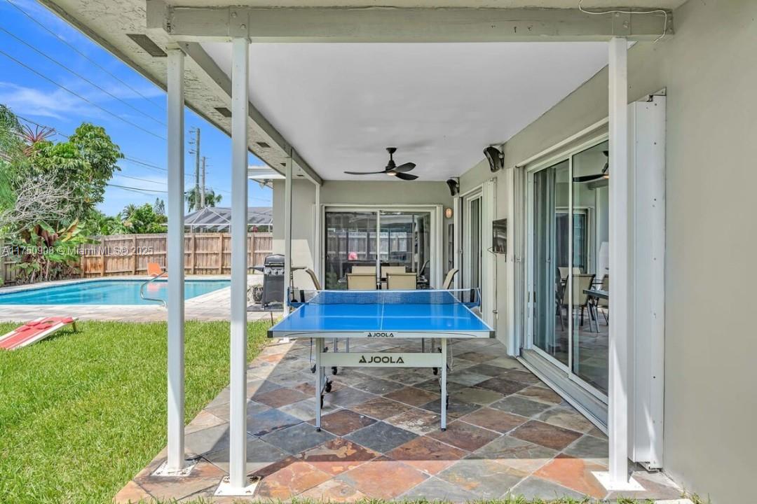 4316 Garfield Street Hollywood, FL 33021 - Photo 19 of 36 a porch with table and chairs