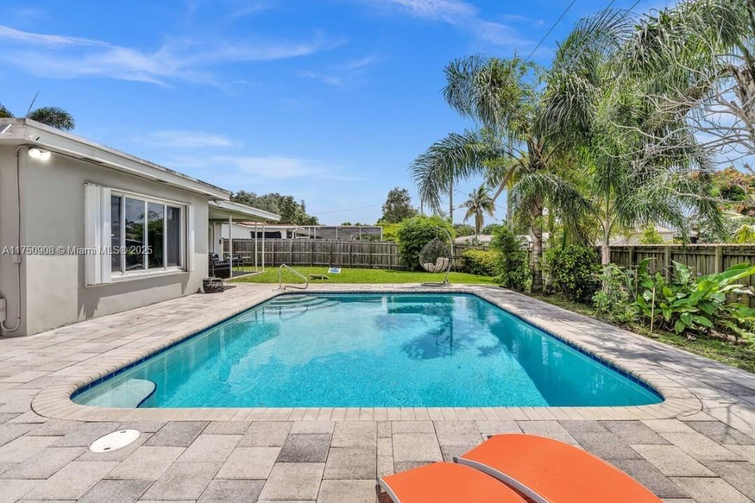 4316 Garfield Street Hollywood, FL 33021 - Photo 2 of 36 a view of swimming pool on a sunny day with lawn chairs