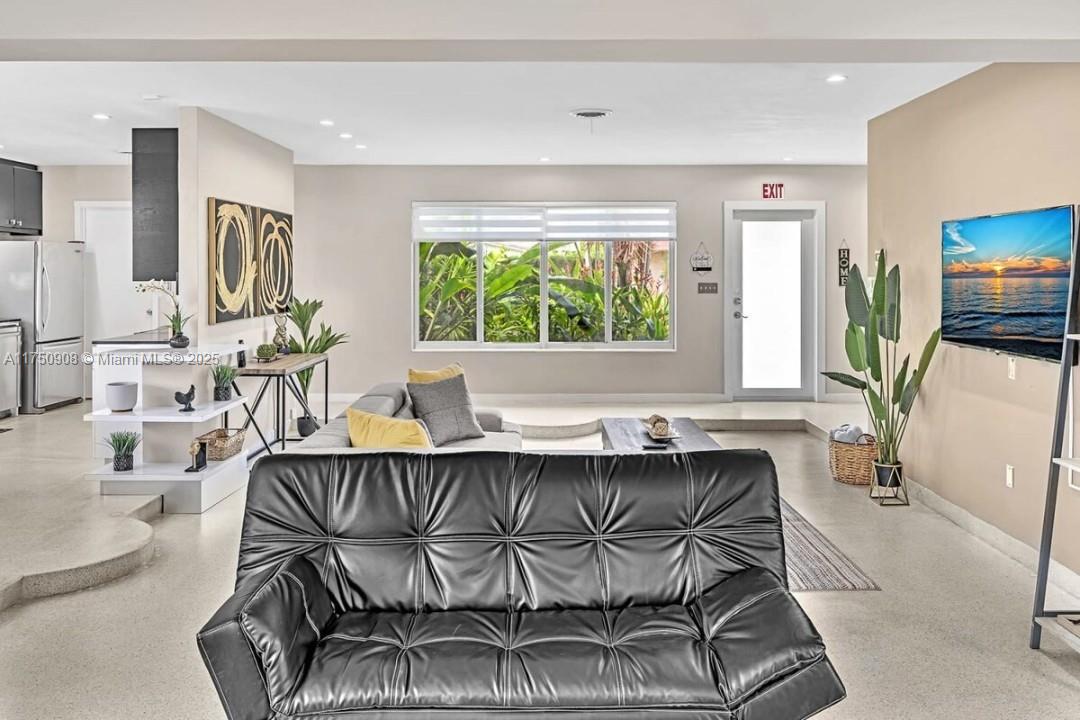 4316 Garfield Street Hollywood, FL 33021 - Photo 24 of 36 a dining room with furniture a window and a chandelier