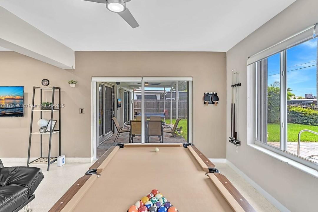 4316 Garfield Street Hollywood, FL 33021 - Photo 25 of 36 a spacious bedroom with a large bed and a large window