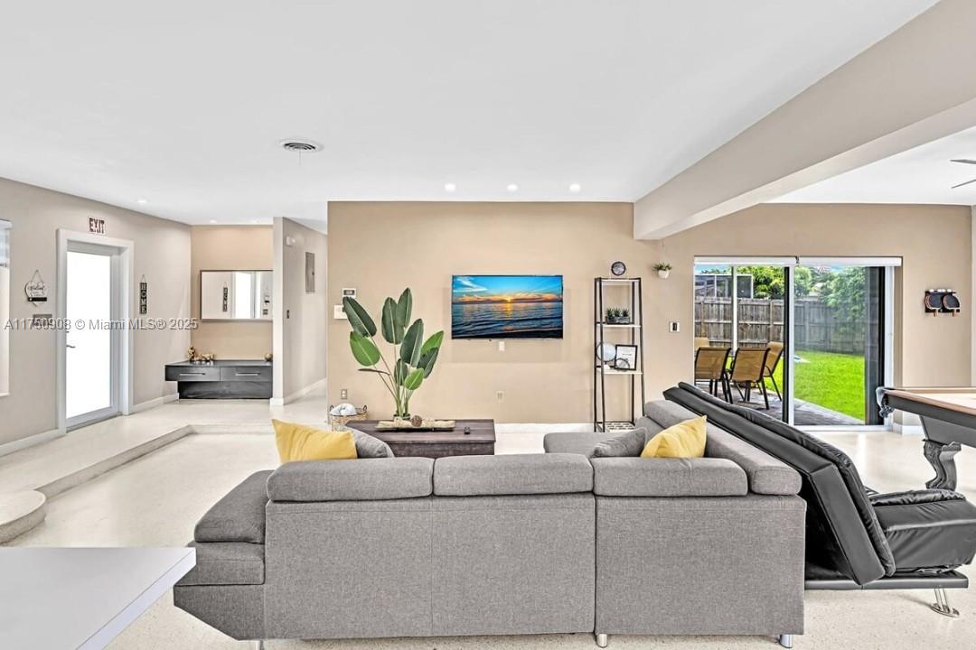 4316 Garfield Street Hollywood, FL 33021 - Photo 26 of 36 a living room with furniture and a flat screen tv