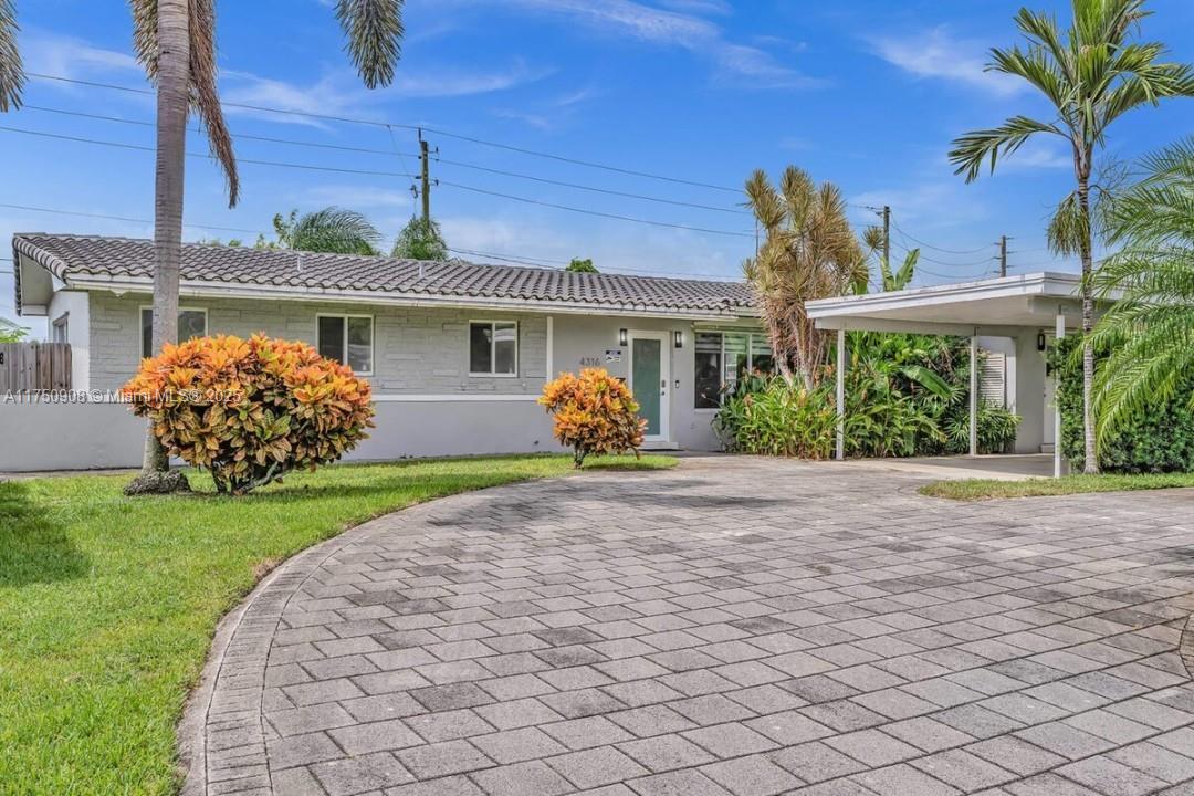 4316 Garfield Street Hollywood, FL 33021 - Photo 31 of 36 a front view of a house with garden