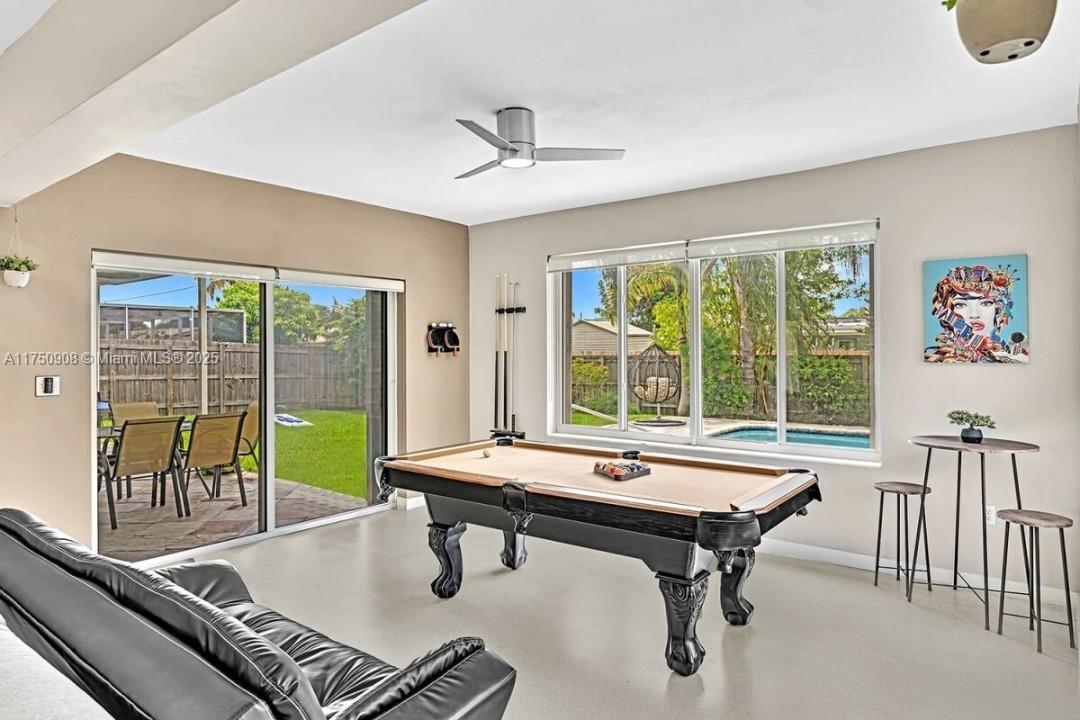 4316 Garfield Street Hollywood, FL 33021 - Photo 34 of 36 a room with furniture pool table and a floor to ceiling window