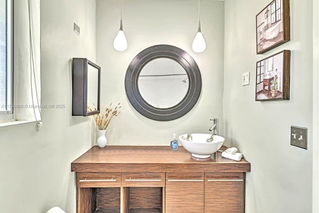 4316 Garfield Street Hollywood, FL 33021 - Photo 5 of 36 a bathroom with a sink and a mirror