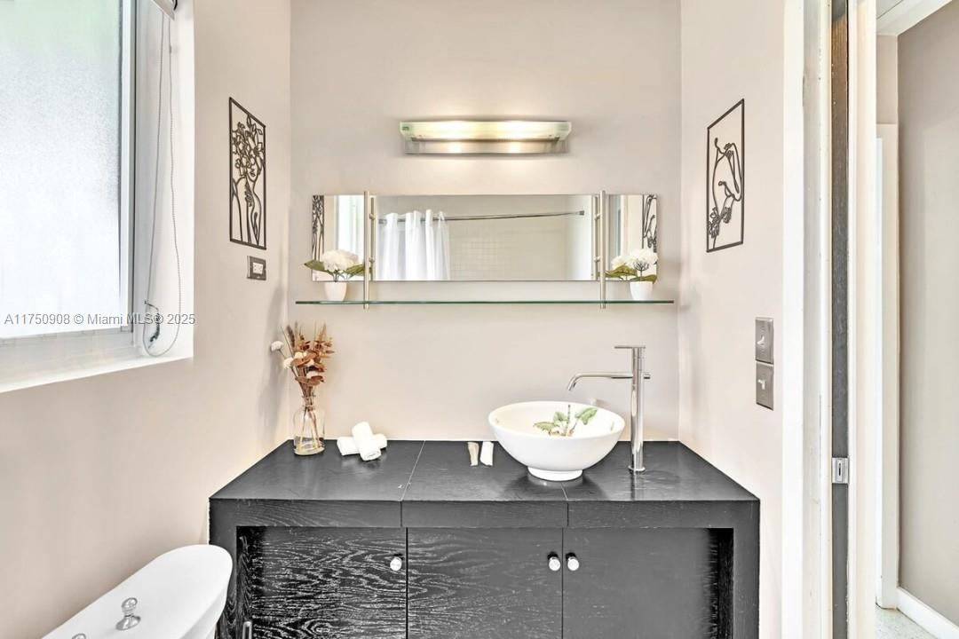 4316 Garfield Street Hollywood, FL 33021 - Photo 6 of 36 a bathroom with a sink a toilet and a mirror