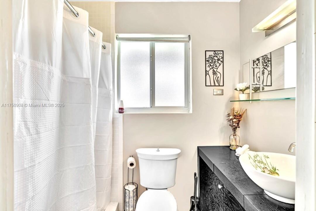 4316 Garfield Street Hollywood, FL 33021 - Photo 7 of 36 a bathroom with a sink toilet and shower