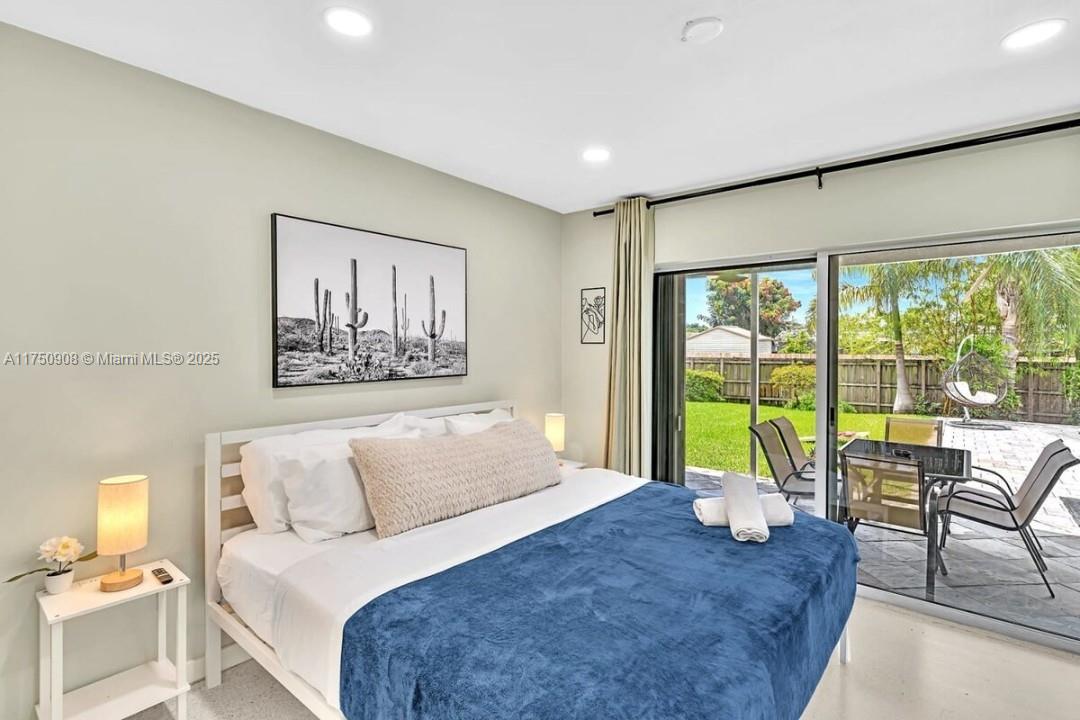 4316 Garfield Street Hollywood, FL 33021 - Photo 8 of 36 a bedroom with a large bed and a large window