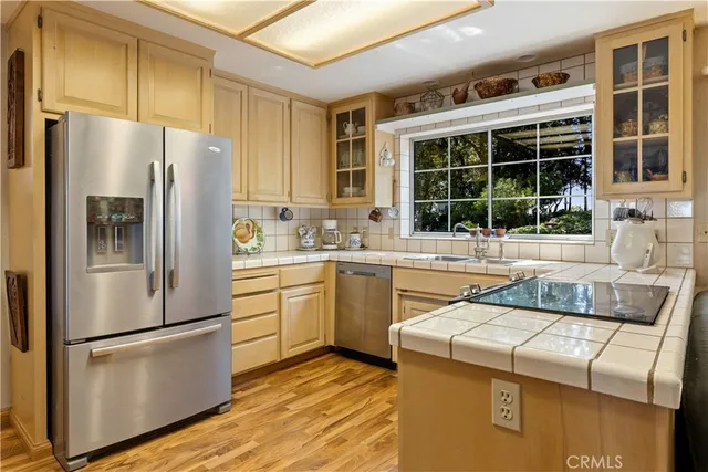a kitchen with stainless steel appliances granite countertop a stove and a refrigerator