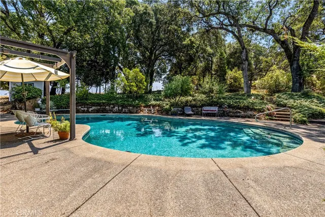 an aerial view of a house with a yard and trees