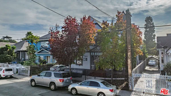 a view of cars parked in front of a house