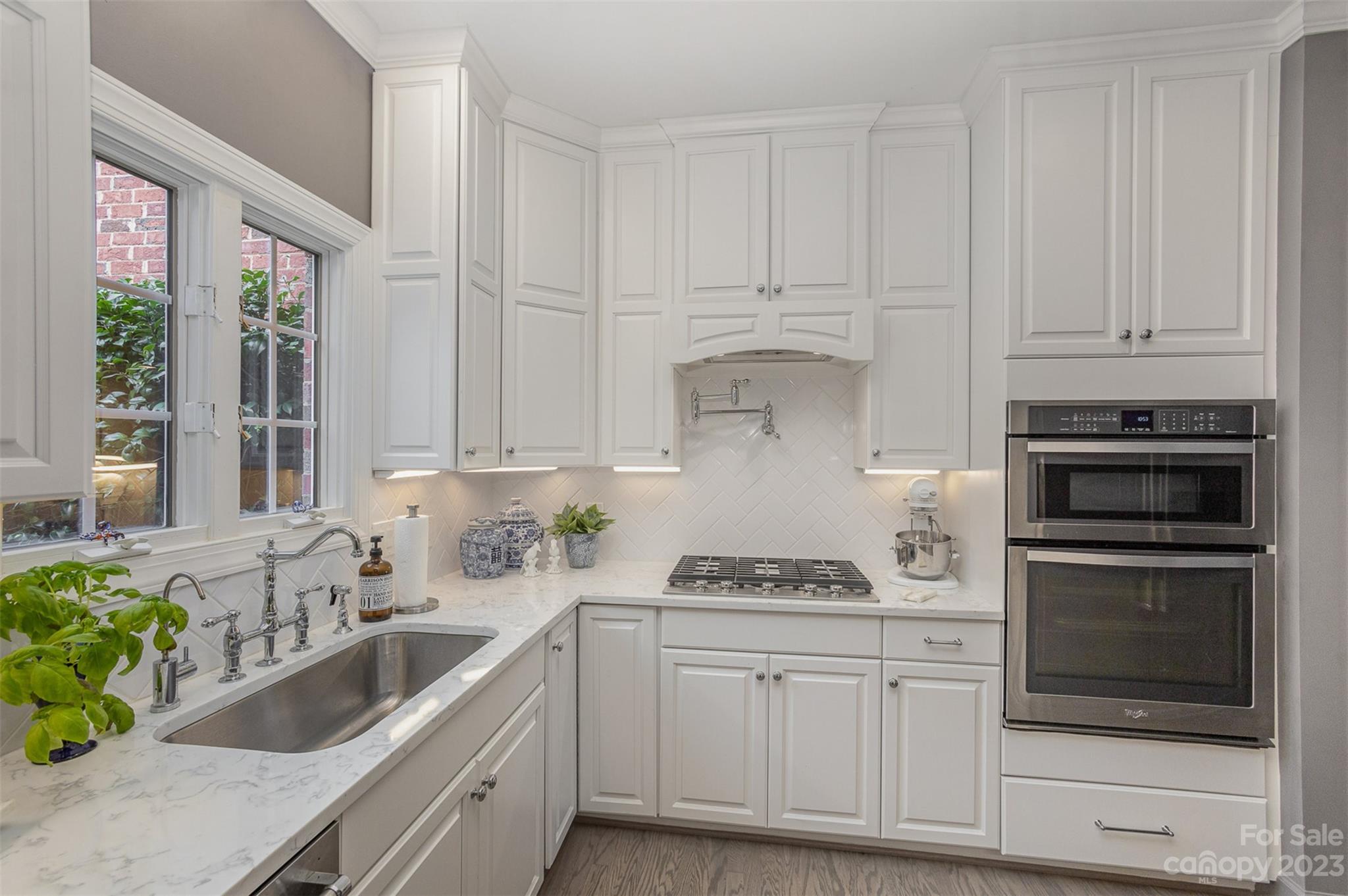 331 Sloane Square Way Charlotte, NC 28211 - Photo 12 of 28 a kitchen with granite countertop white cabinets and stainless steel appliances