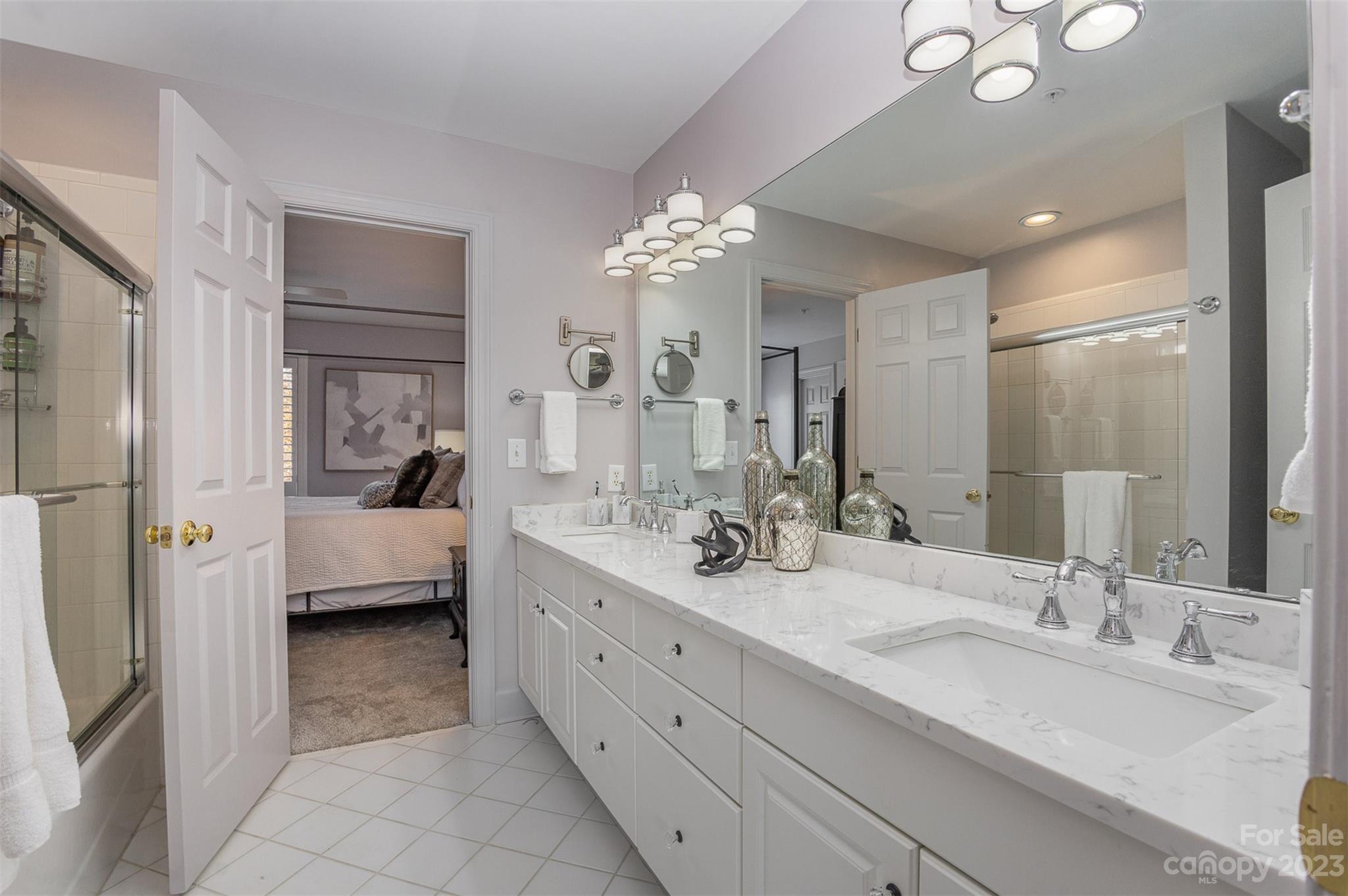331 Sloane Square Way Charlotte, NC 28211 - Photo 27 of 28 a en suite bathroom with double sink and a large mirror