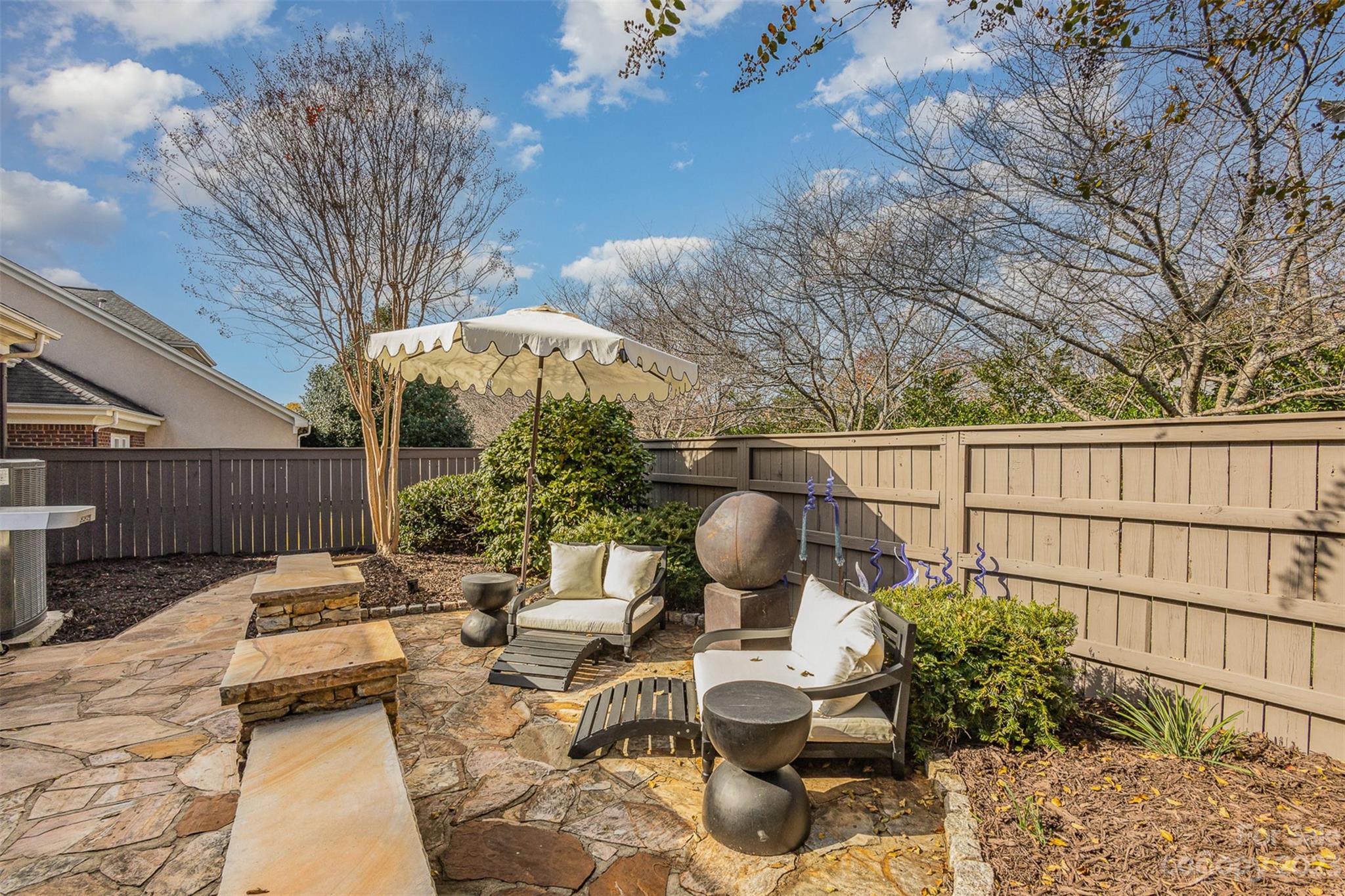331 Sloane Square Way Charlotte, NC 28211 - Photo 3 of 28 a backyard of a house with table and chairs