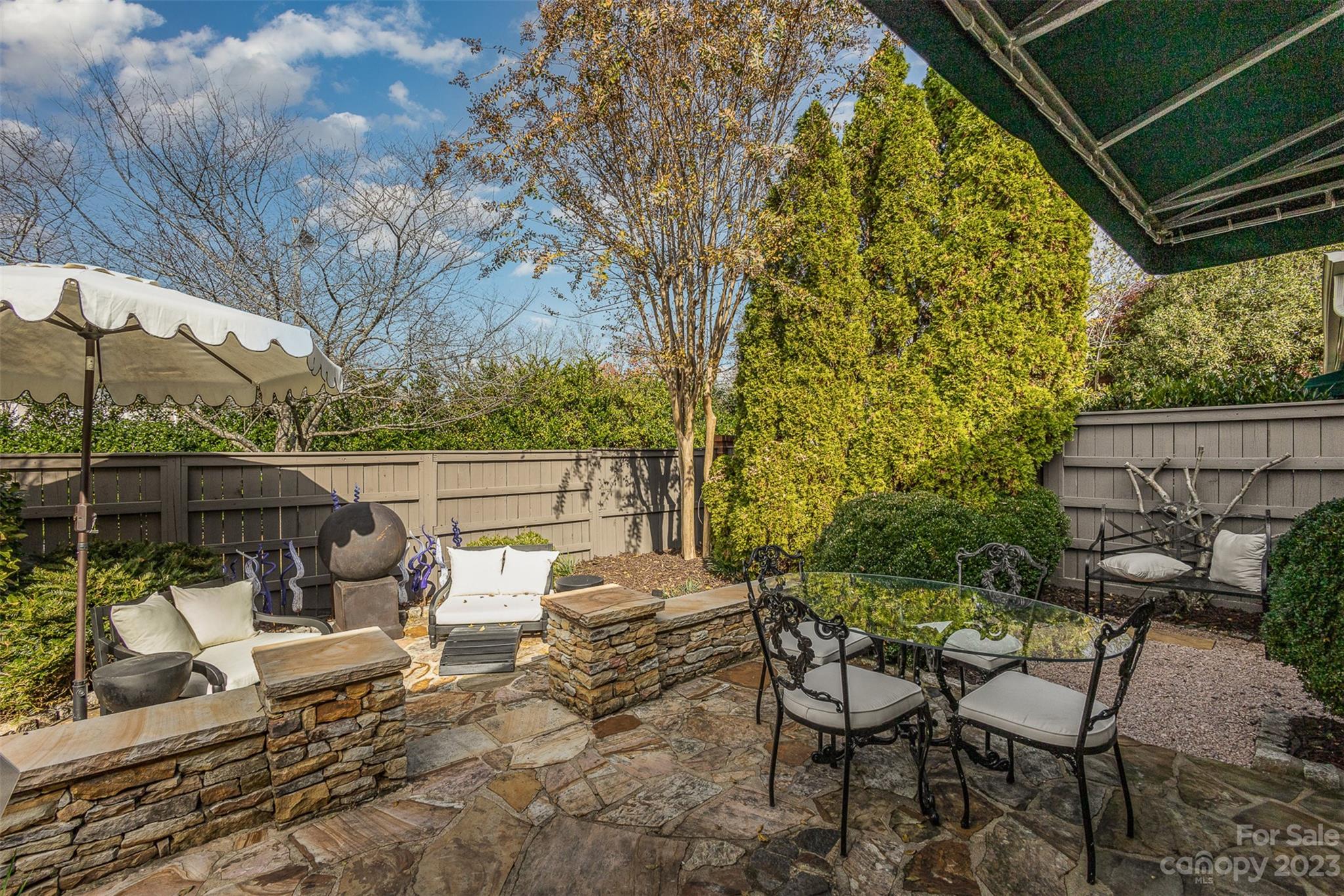 331 Sloane Square Way Charlotte, NC 28211 - Photo 4 of 28 a view of a patio with table and chairs and wooden fence