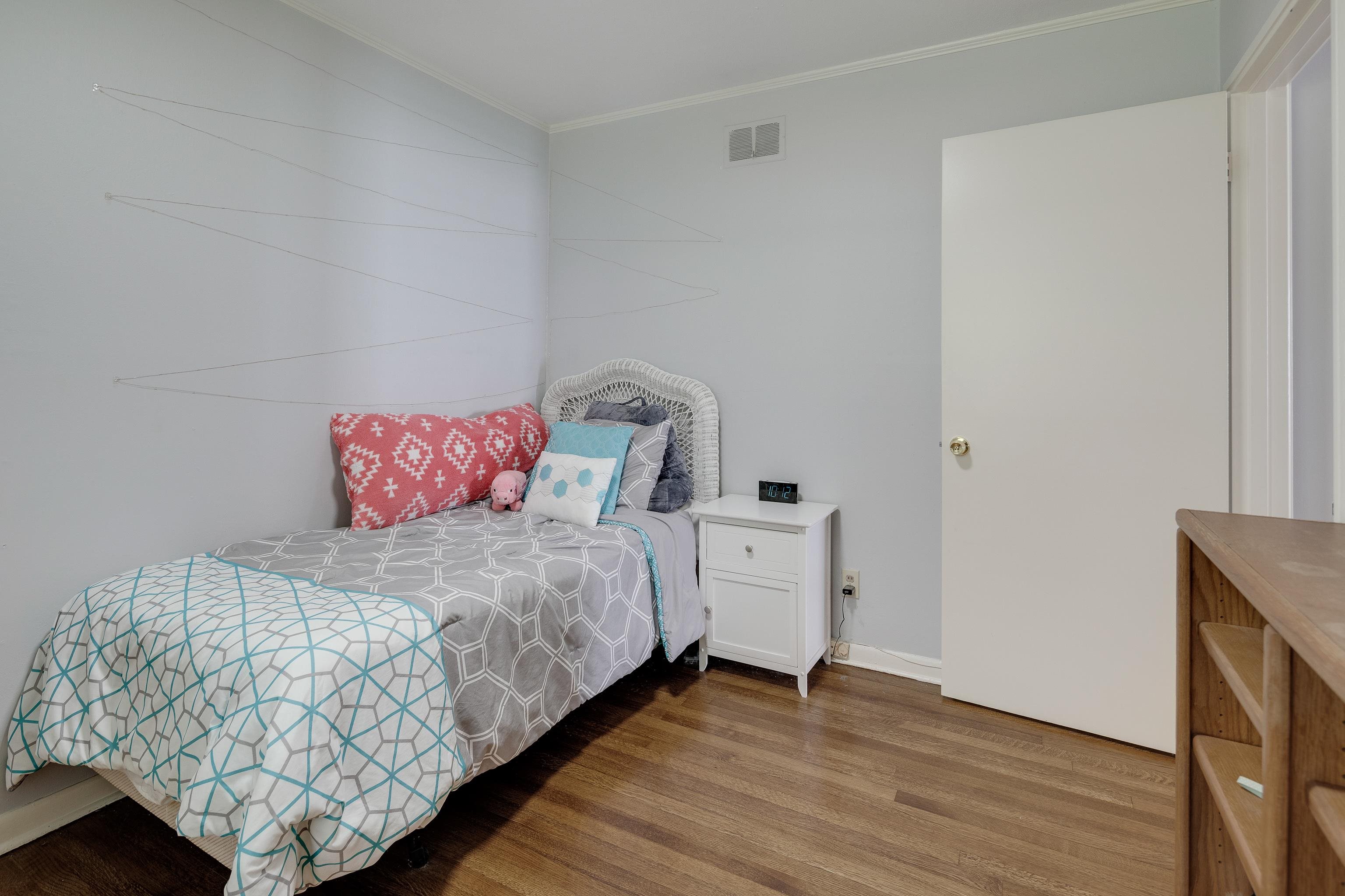 4796 Quince Road Memphis, TN 38117 - Photo 14 of 22 a bedroom with a bed and wooden floor