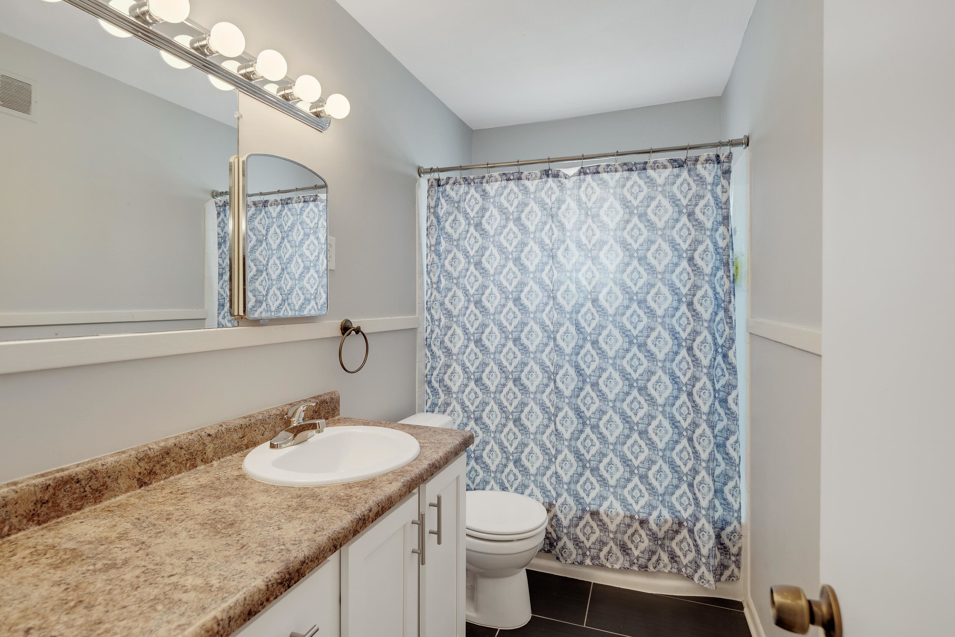 4796 Quince Road Memphis, TN 38117 - Photo 19 of 22 a bathroom with a granite countertop sink and a mirror