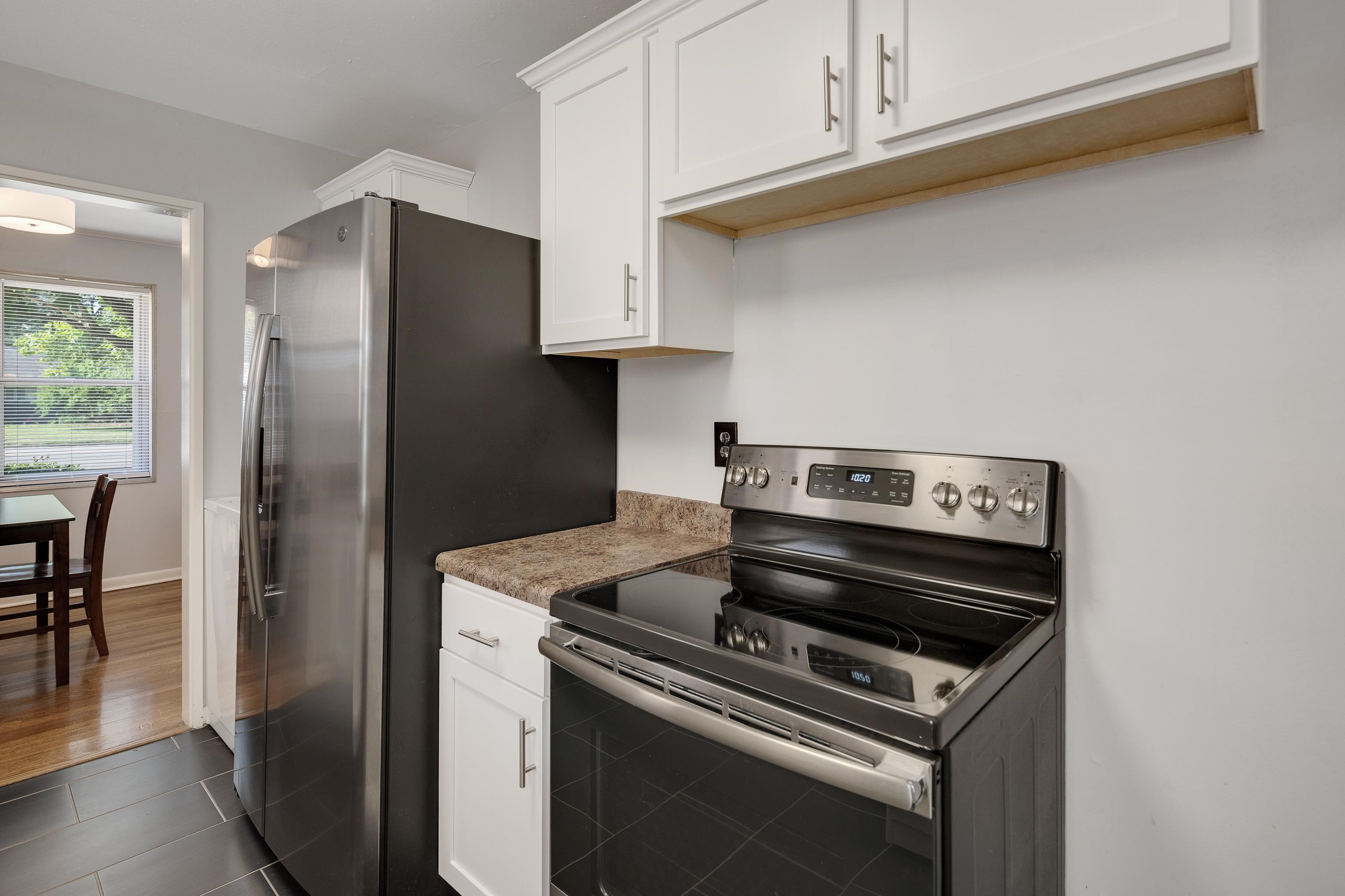 4796 Quince Road Memphis, TN 38117 - Photo 8 of 22 a kitchen with stainless steel appliances granite countertop a stove a refrigerator and a microwave