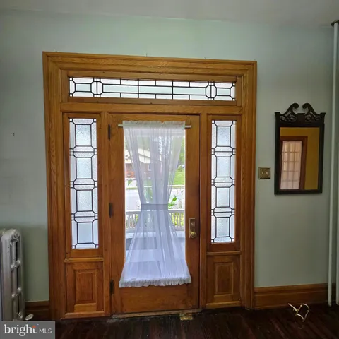 a view of an empty room and wooden floor