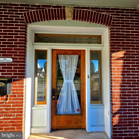 a kitchen that has a stove and a wooden floor