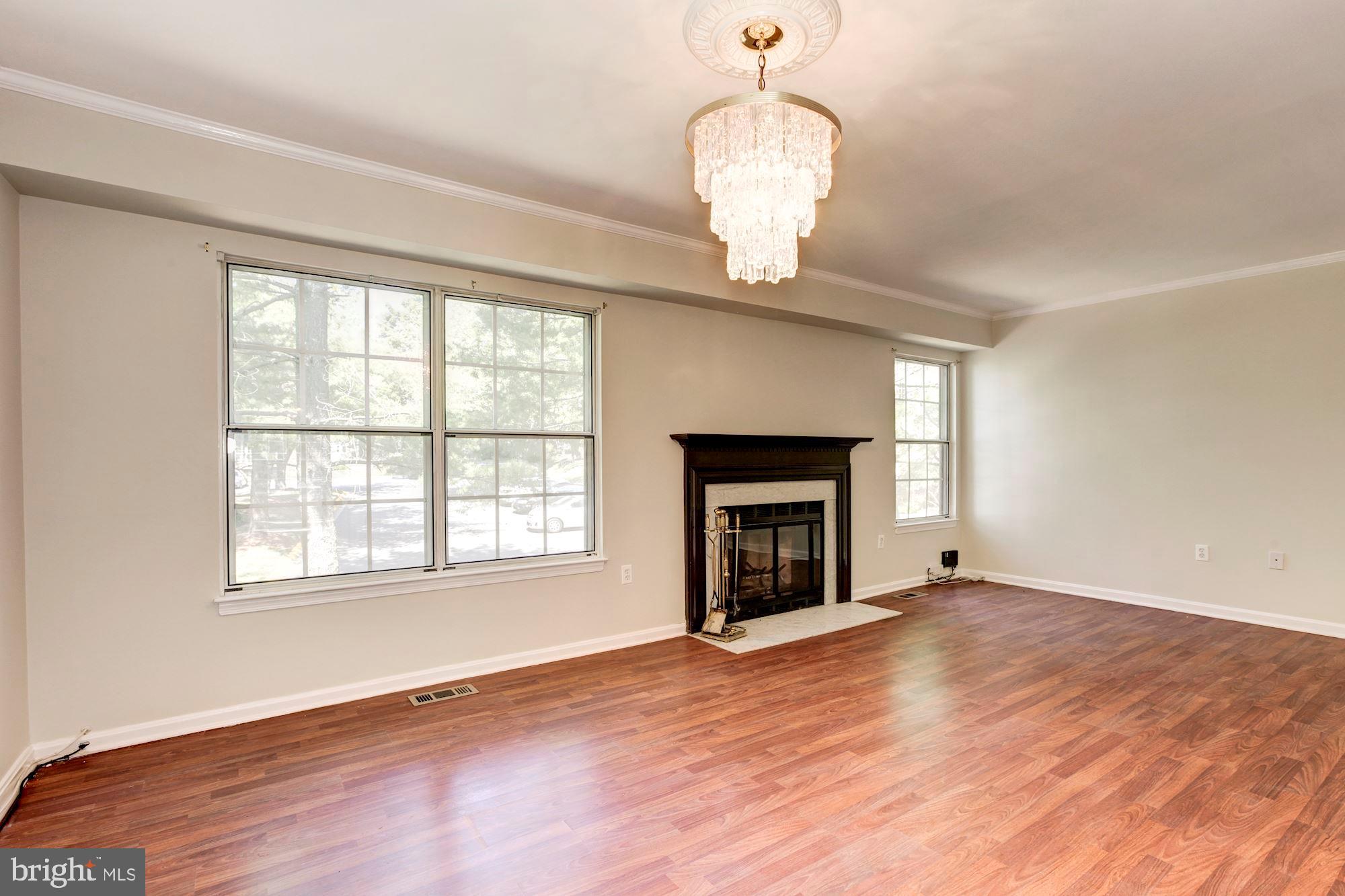 14518 MacBeth Drive Silver Spring, MD 20906 - Photo 15 of 43 a view of an empty room with wooden floor fireplace and a window