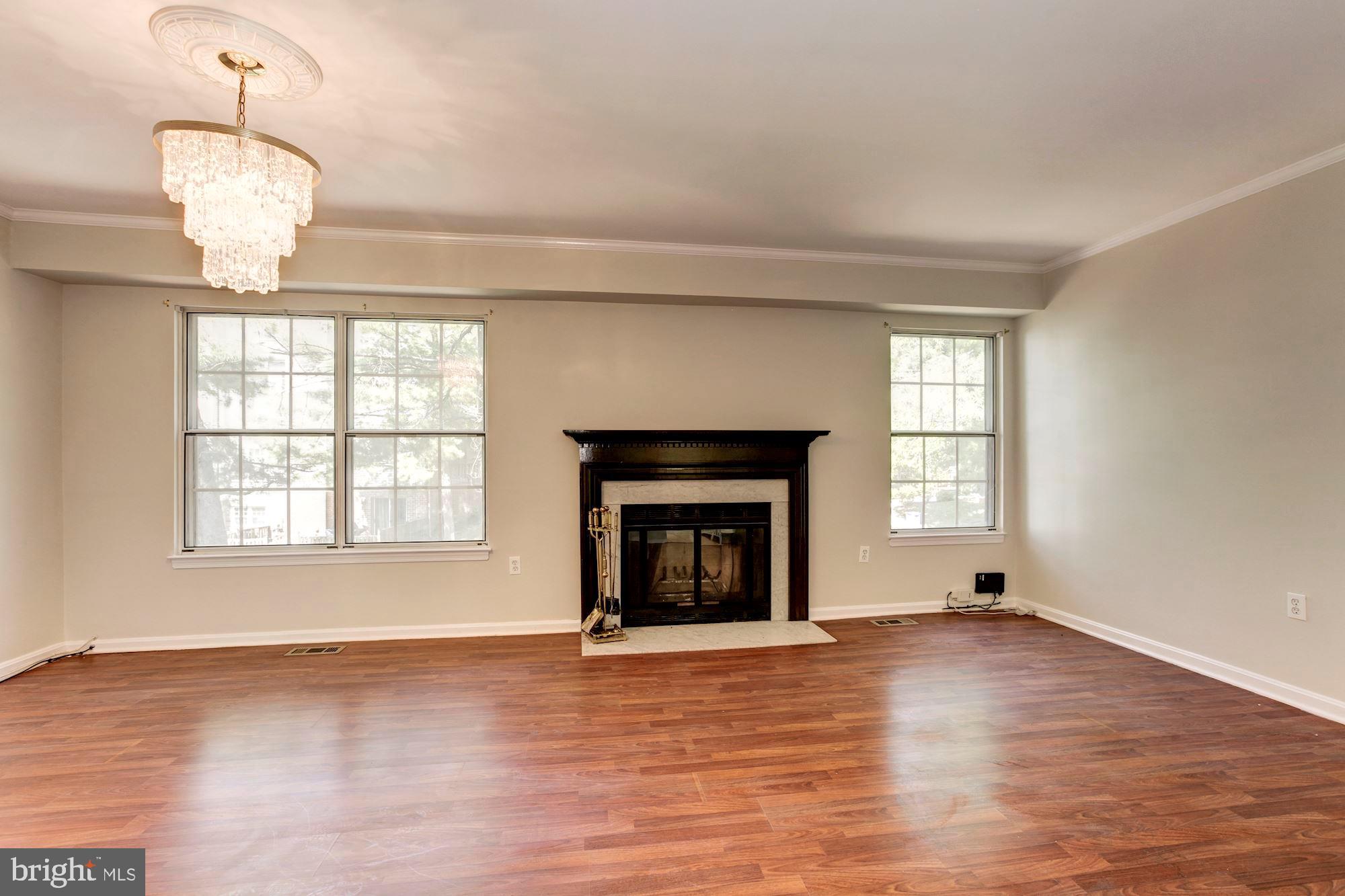 14518 MacBeth Drive Silver Spring, MD 20906 - Photo 20 of 43 an empty room with wooden floor fireplace and windows