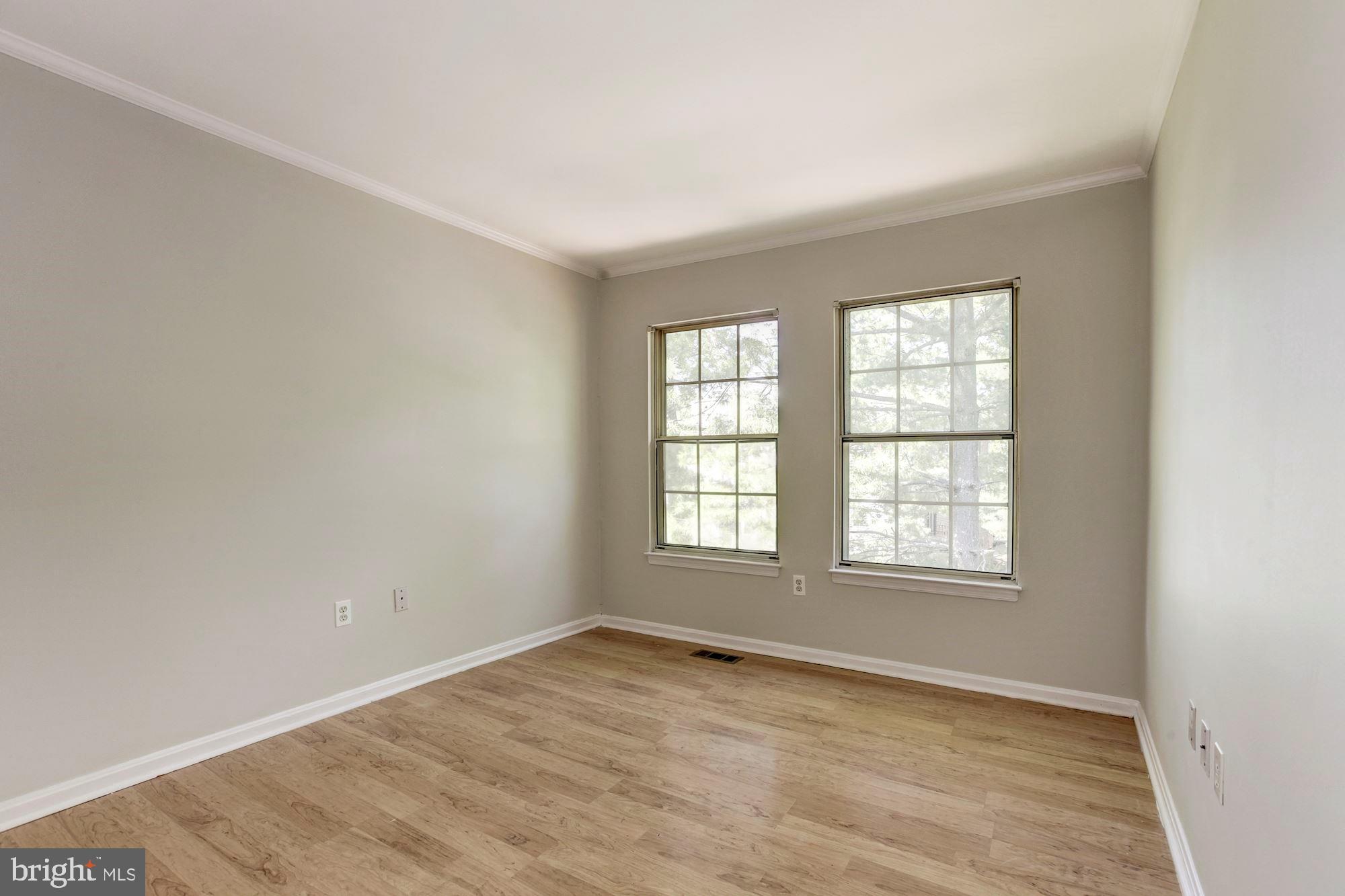 14518 MacBeth Drive Silver Spring, MD 20906 - Photo 27 of 43 an empty room with wooden floor and windows