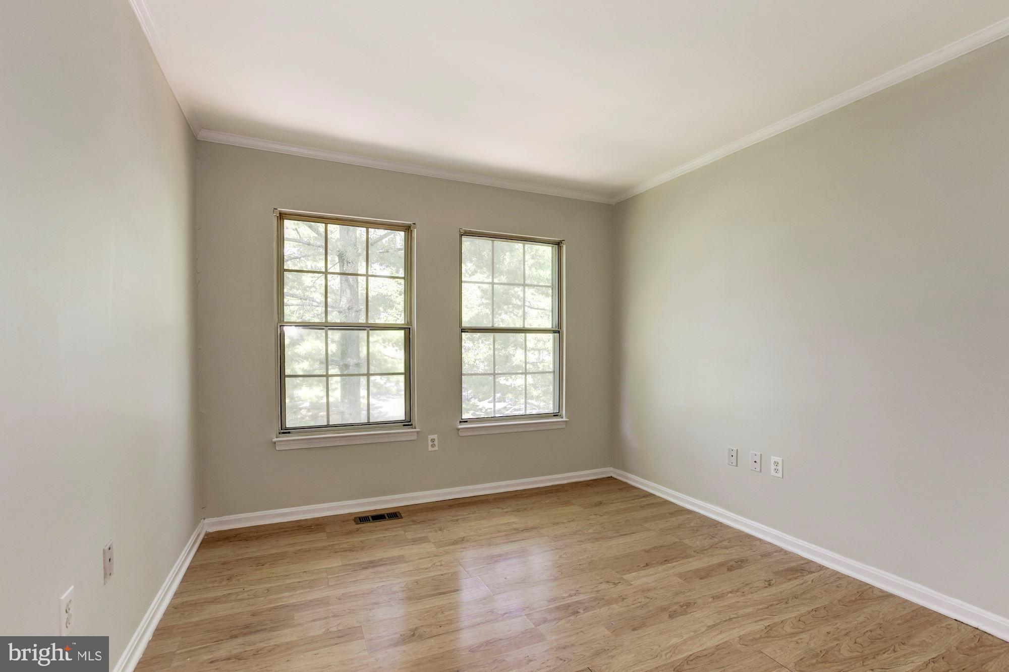 14518 MacBeth Drive Silver Spring, MD 20906 - Photo 28 of 43 an empty room with wooden floor and windows