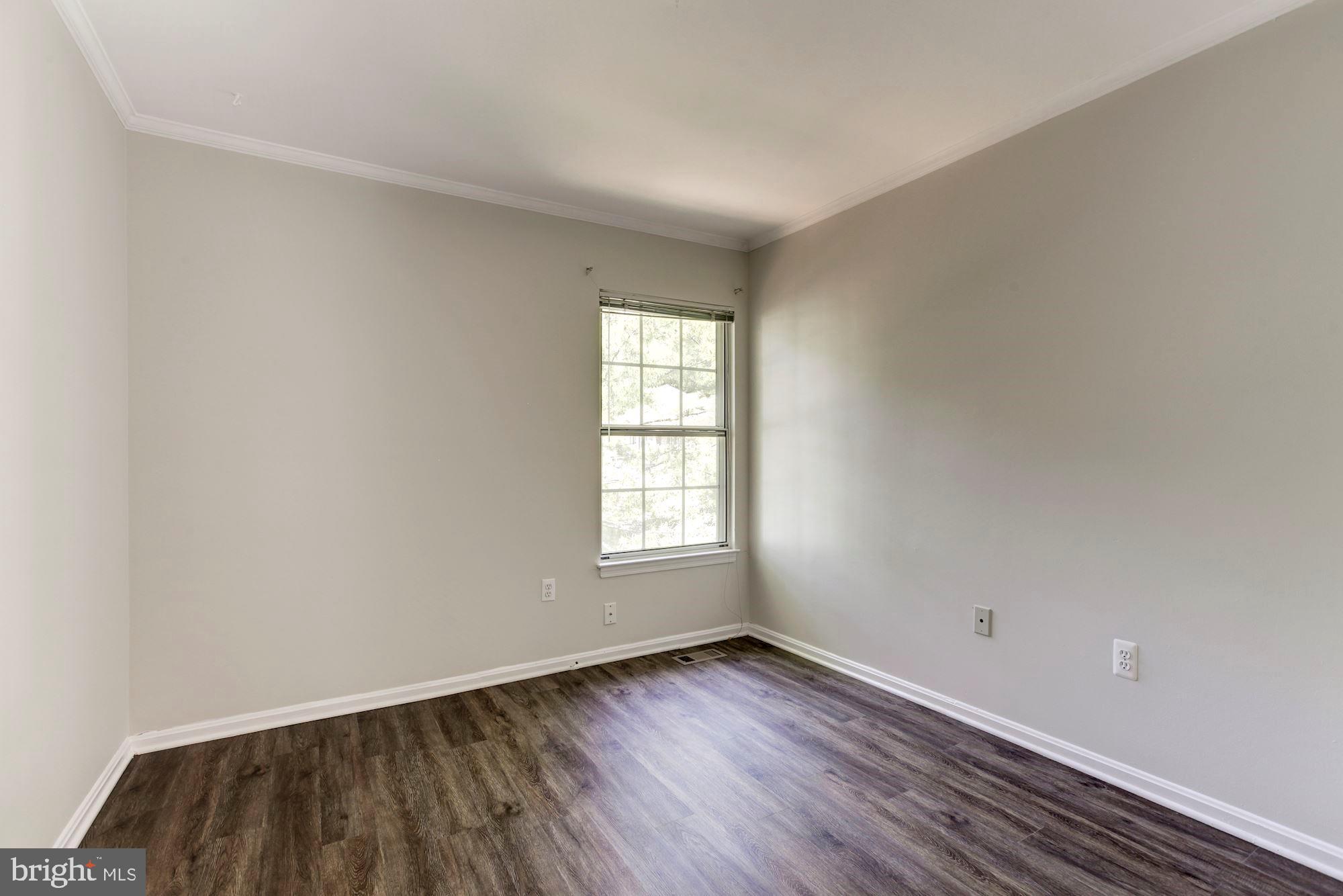 14518 MacBeth Drive Silver Spring, MD 20906 - Photo 29 of 43 an empty room with wooden floor and windows