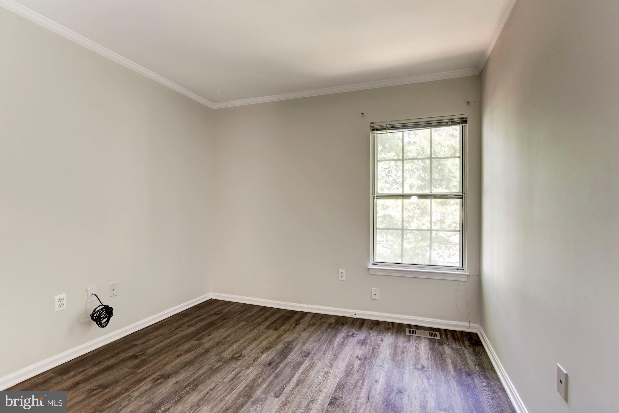 14518 MacBeth Drive Silver Spring, MD 20906 - Photo 30 of 43 an empty room with wooden floor and windows