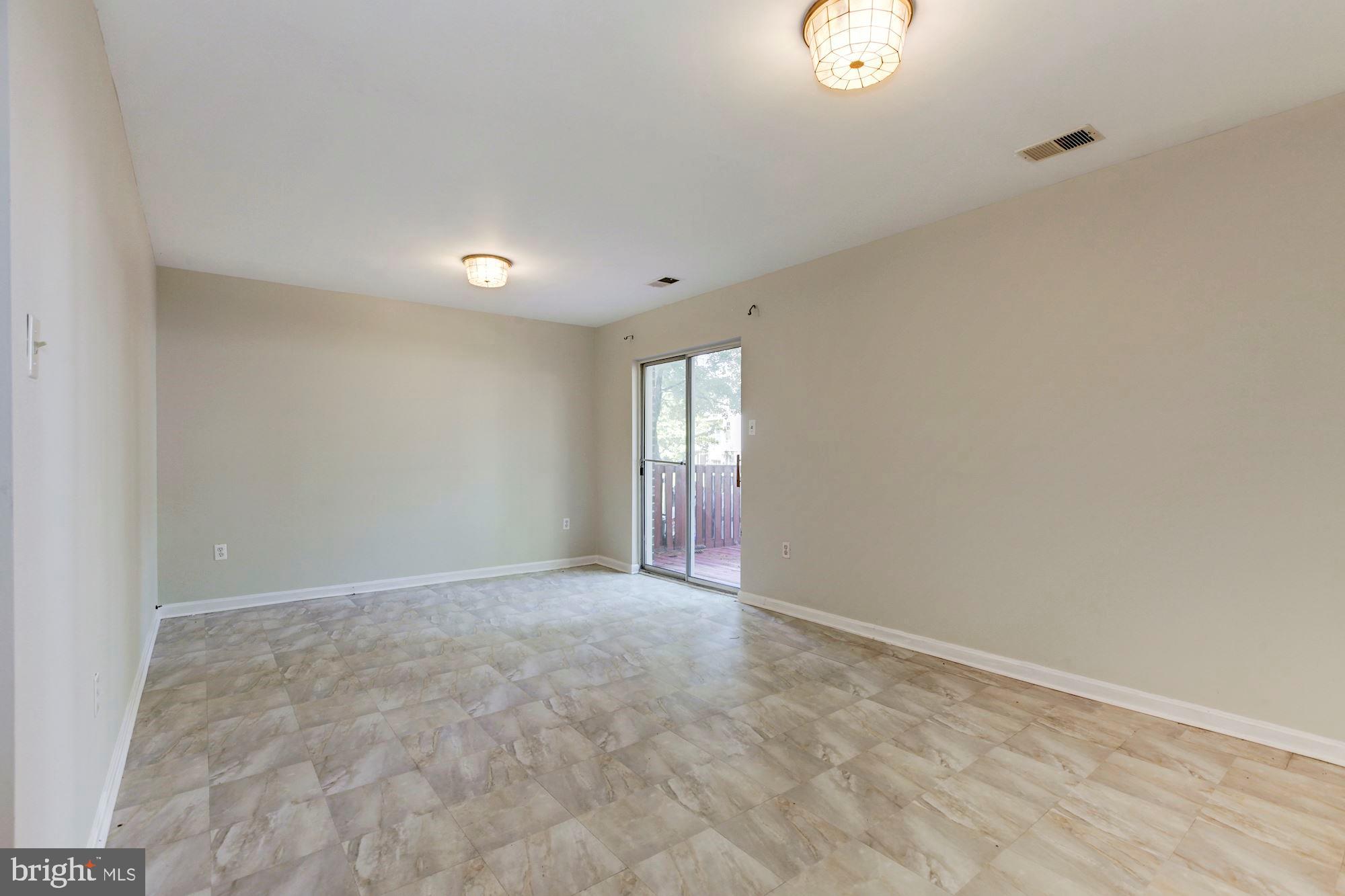 14518 MacBeth Drive Silver Spring, MD 20906 - Photo 32 of 43 a view of an empty room with window and wooden floor