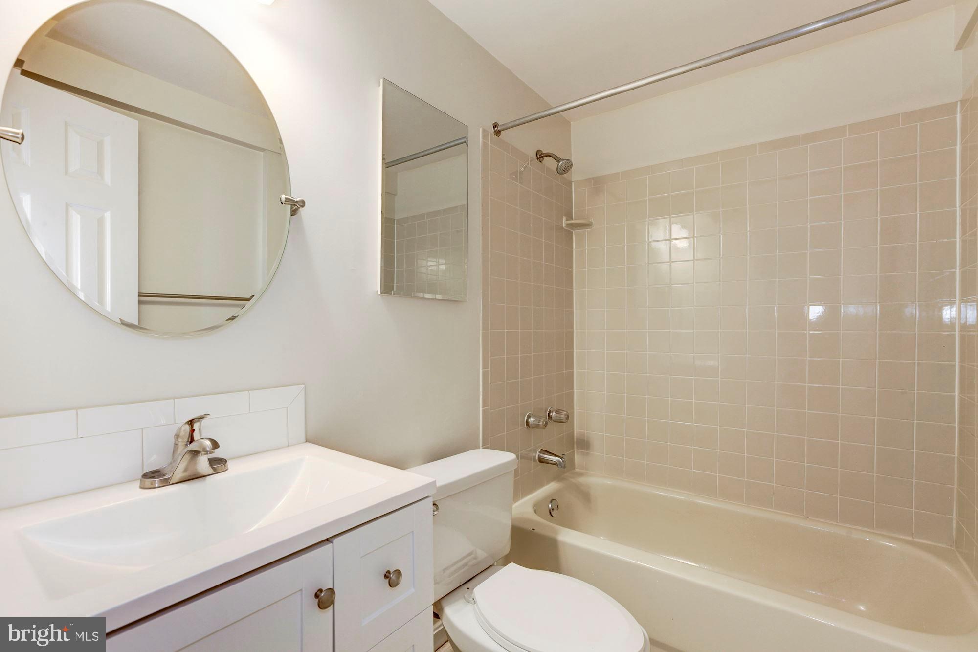 14518 MacBeth Drive Silver Spring, MD 20906 - Photo 37 of 43 a bathroom with a sink toilet tub vanity and shower
