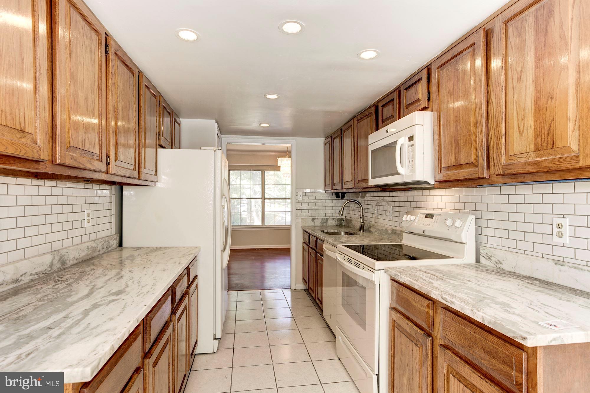 14518 MacBeth Drive Silver Spring, MD 20906 - Photo 9 of 43 a kitchen with a sink stove and cabinets