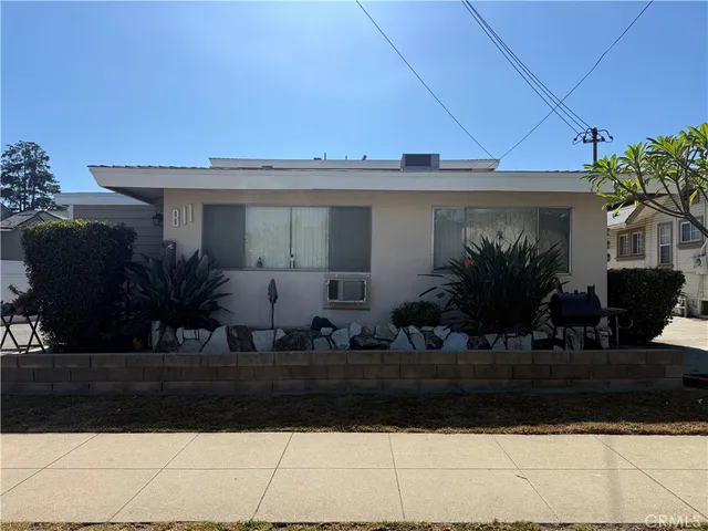a front view of house with yard and trees