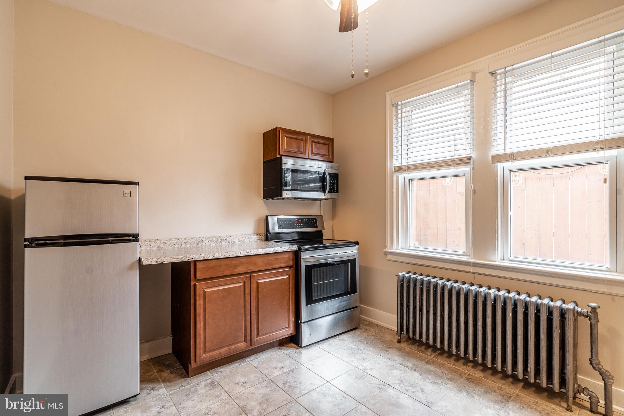 4339 Main Street, Unit R Philadelphia, PA 19127 - Photo 3 of 14 a kitchen with a refrigerator and a stove top oven