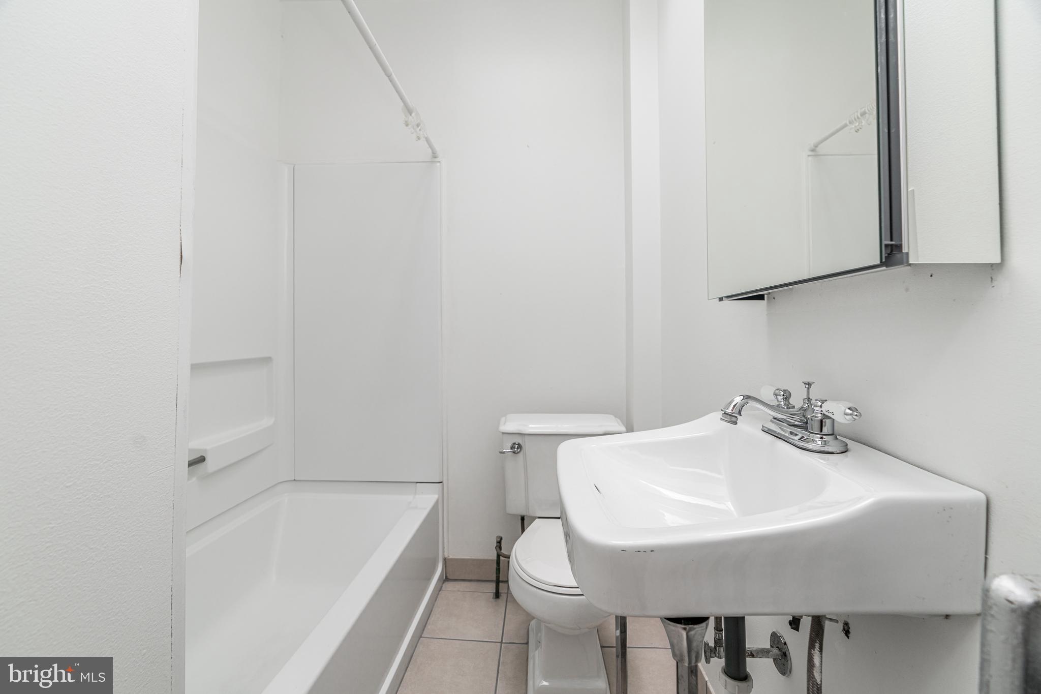 4339 Main Street, Unit R Philadelphia, PA 19127 - Photo 8 of 14 a bathroom with a sink a toilet and bathtub