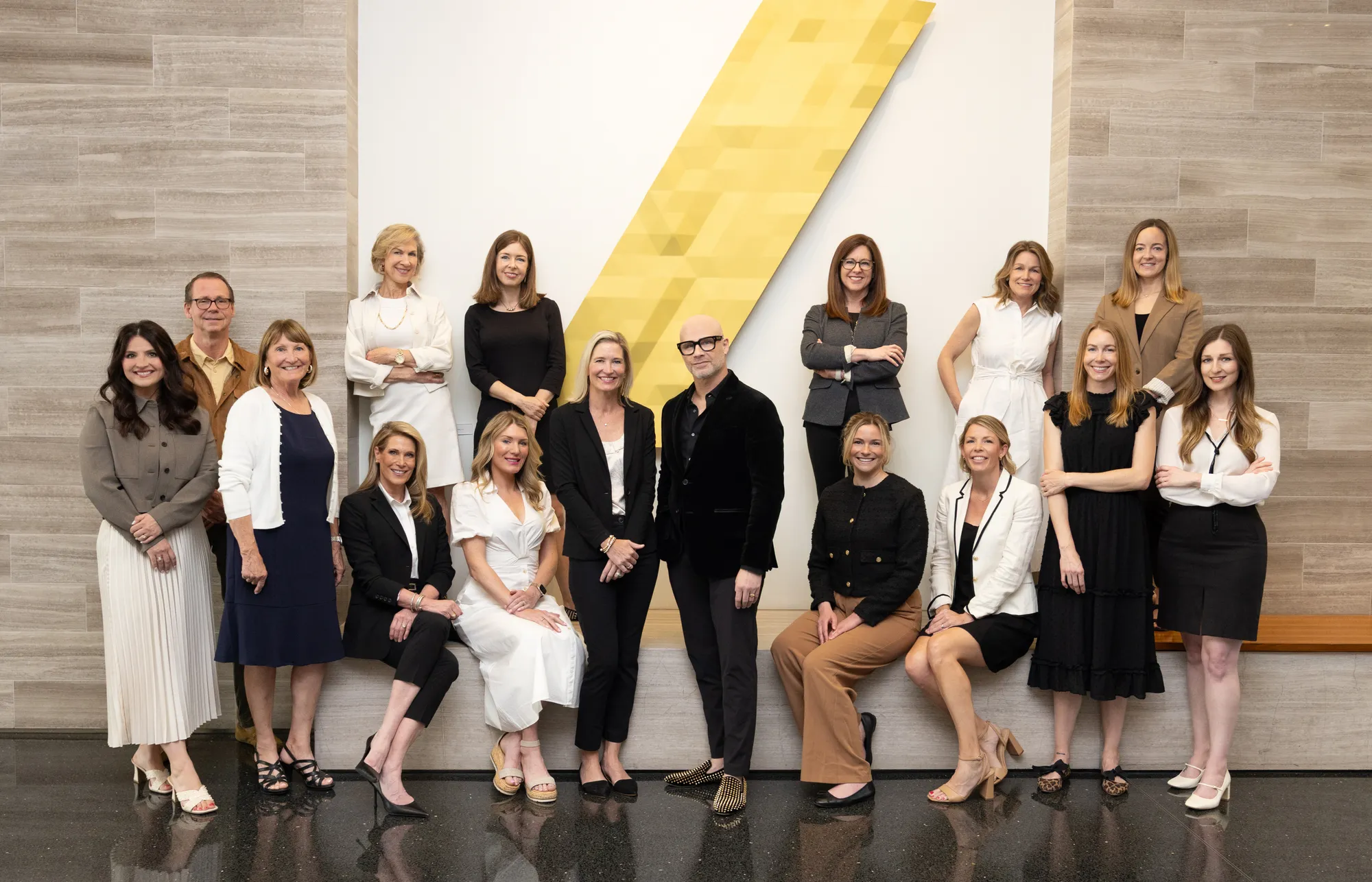 16 team members standing together