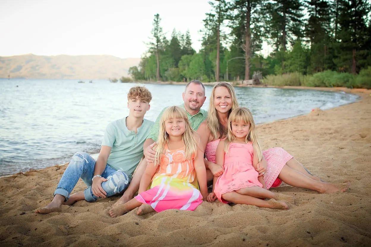 A family posing for a picture on the beach