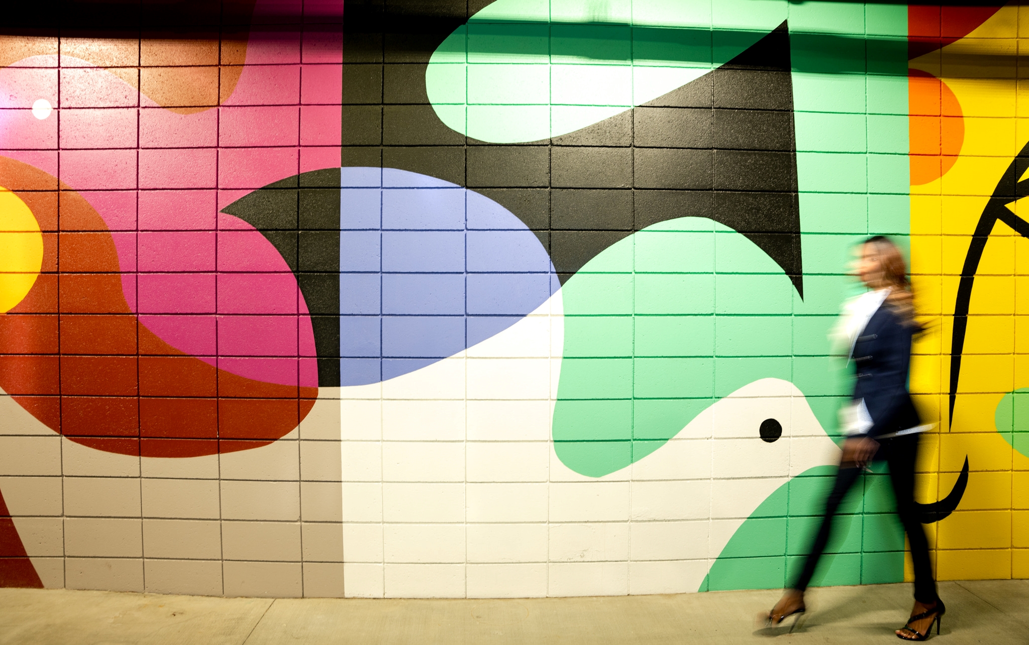 A woman standing in front of graffiti-covered wall