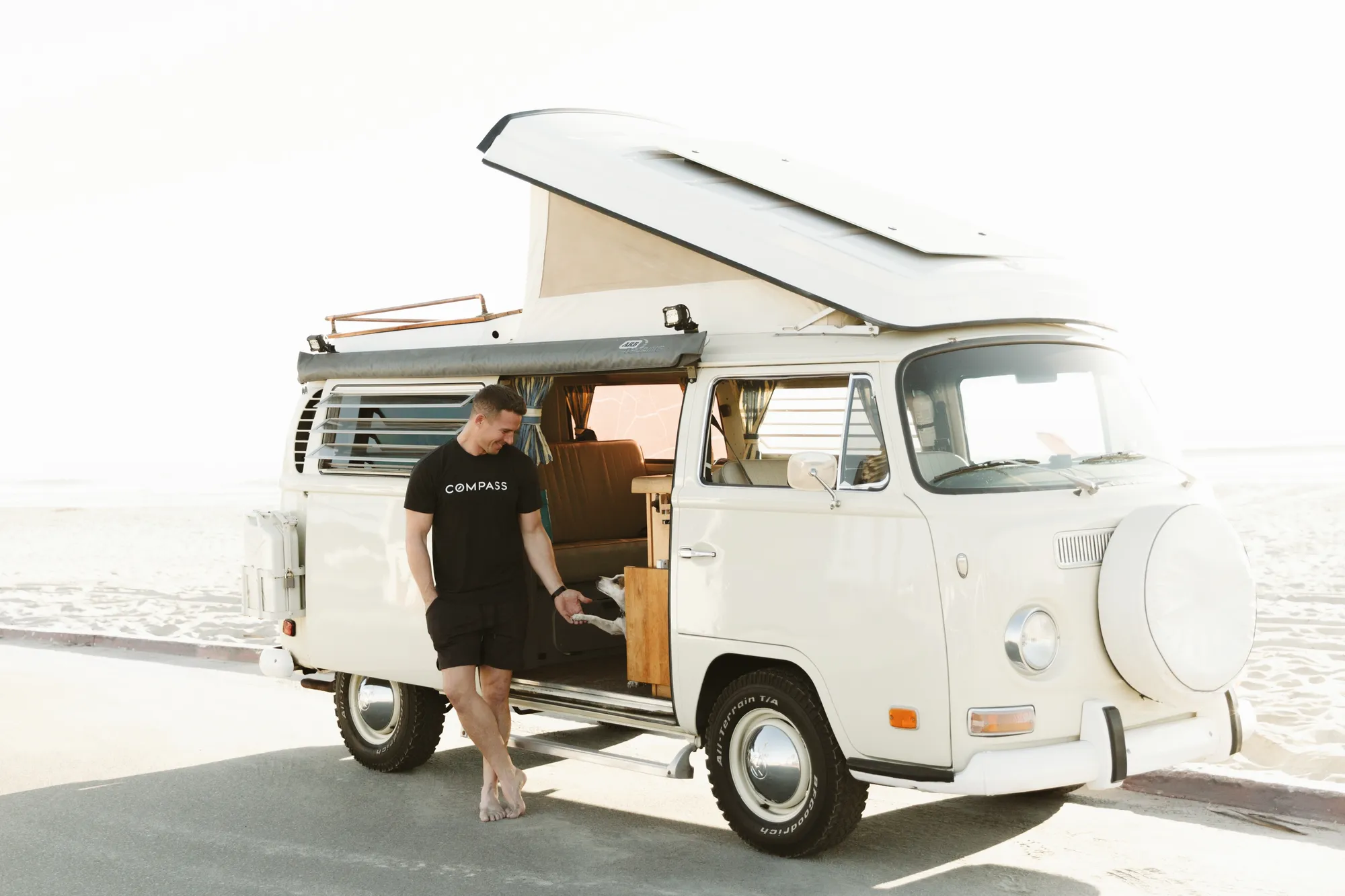 A man and woman standing on a van.