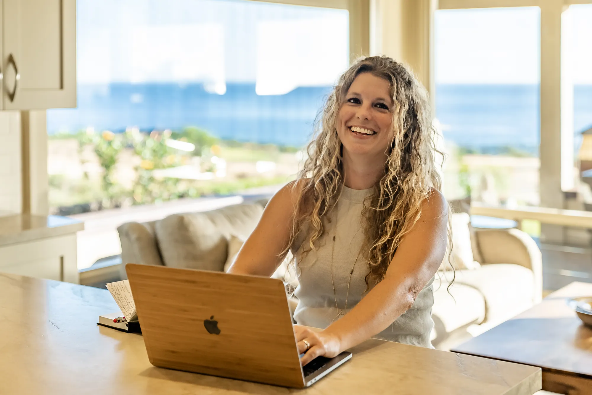 A woman sitting at a table with a laptop.
