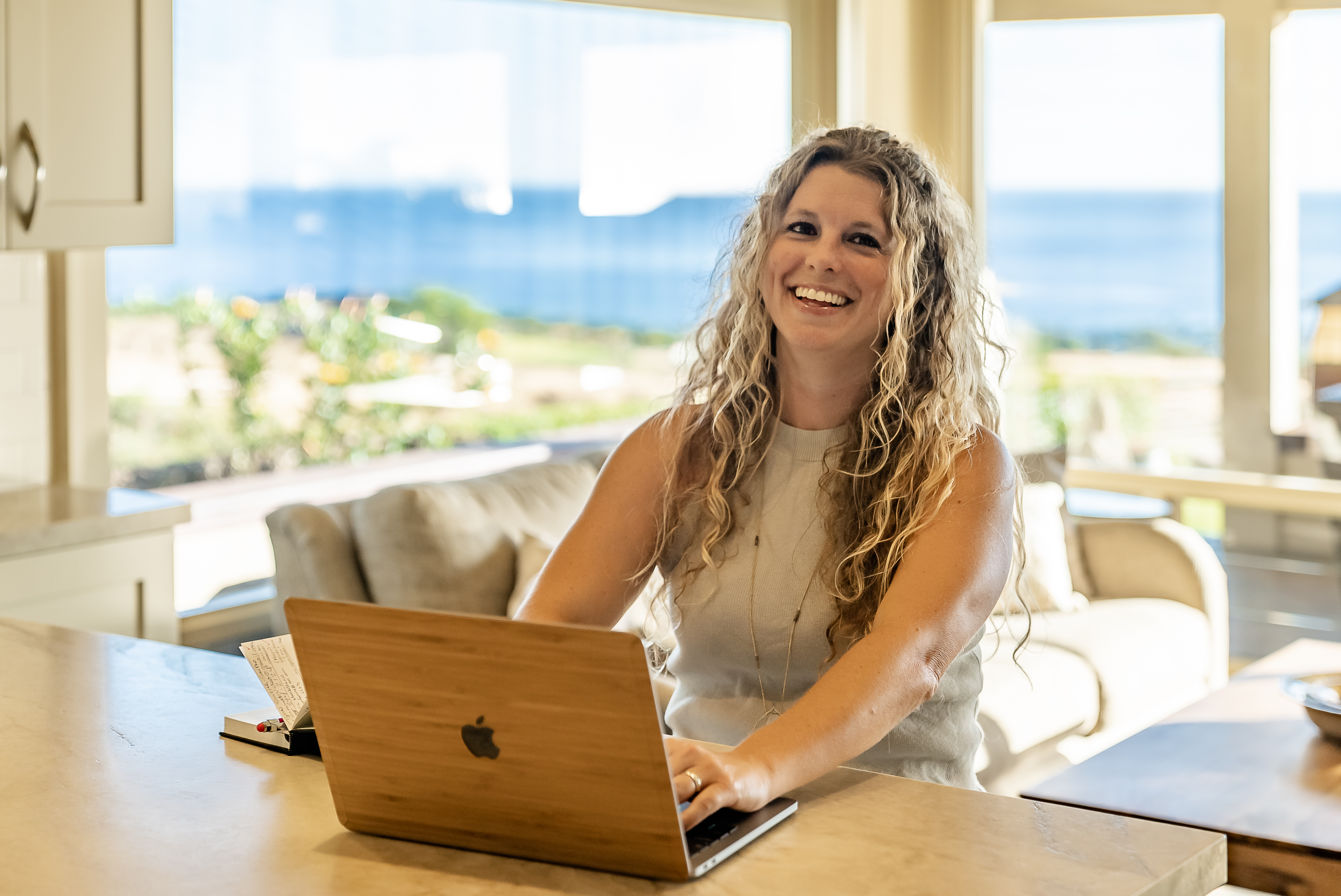 A woman sitting at a table with a laptop.